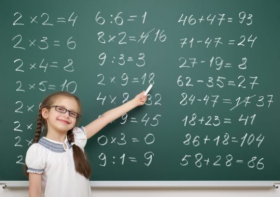 girl with math numbers on school board